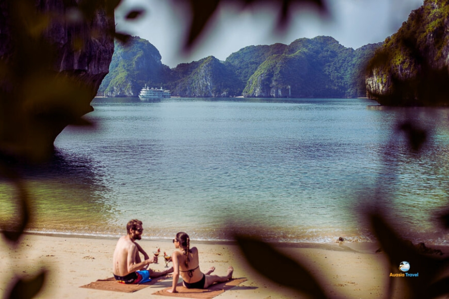 Couple relaxing on Lan Ha Bay beach Vietnam – Auasia Travel